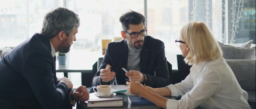 Business people sitting around a table talking